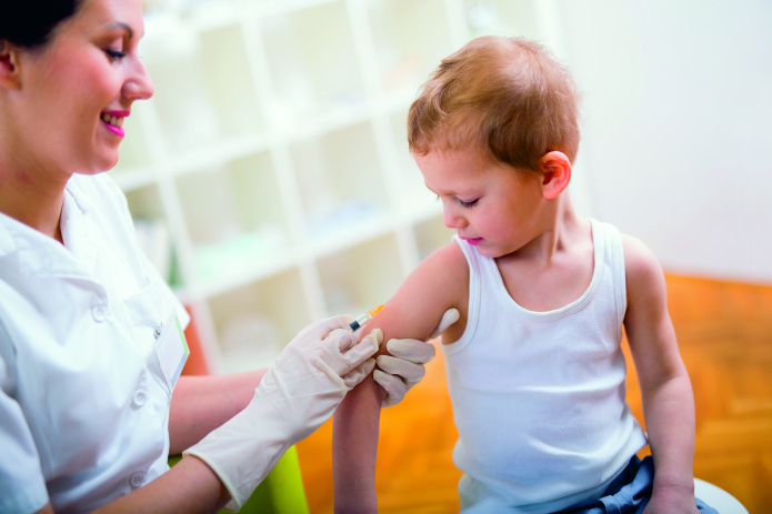 Pediatrician makes vaccination to small boy