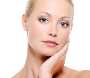 Portrait of young woman with healthy complexion - white background